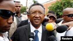 FILE - Madagascar's presidential candidate Hery Rajaonarimampianina arrives to cast his ballot at a polling centre in Tsimbazaza area of Madagascar's capital Antananarivo, Dec. 20, 2013. 