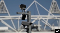FILE - A security cctv camera is seen by the Olympic Stadium at the Olympic Park in London. 