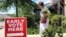 A library patron passes by a precinct sign outside the Roosevelt Thompson Library, May 7, 2018, as early voting opened in Little Rock, Arkansas. 