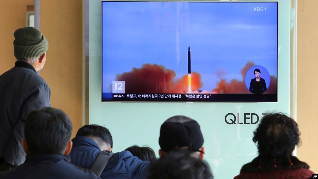 People watch a TV screen showing file footage of North Korea's missile launch at Seoul Railway Station in Seoul, South Korea, Nov. 21, 2017.