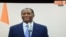 This picture taken on a television screen in Abidjan on Feb. 27, 2014 shows Ivorian president Alassane Ouattara making an announcement during a broadcast by the Ivorian television from Paris. 