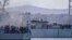 FILE - Migrants arrive in Porto Empedocle, Sicily, aboard two military ships after being transferred from the island of Lampedusa, where a number of small boats carrying migrants arrived a few days earlier, July 27, 2020. 