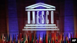 FILE - The logo of the United Nations Educational, Scientific and Cultural Organisation (UNESCO) is seen druing a conference at UNESCO headquarters in Paris, France, Nov. 4, 2017. 