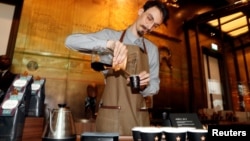 An employee prepares a coffee inside the new Starbucks Reserve Roastery flagship in downtown Milan, Italy, Sept. 4, 2018.