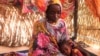 FILE - Hanan Idriss, a mother of two, speaks in the border town of Adre, Chad, Nov. 14, 2023. Idriss said RSF and Arab militiamen attacked her house in Ardamata, Sudan, and tried to sexually assault her and her sister. Women's rights dwindled last year, a U.N. report says.