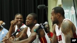 Miami Heat players, from left, Chris Bosh, Dwyane Wade, and LeBron James share laugh during news conference in Coral Gables, Florida, 27 Sept 2010