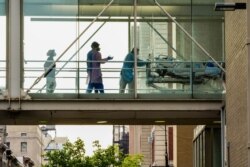 FILE - A view of medical personnel working in Mt. Sinai Hospital Morningside during the coronavirus pandemic on May 18, 2020 in New York City.