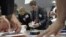 Members of the local electoral commission count ballots at a polling station after the parliamentary election in Minsk, Belarus, September 23, 2012.