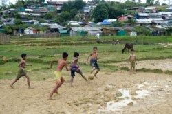 Rohingya refugee children play football at Thankhali refugee camp, in Ukhia on Oct. 6, 2020.