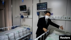 Doctor Hangzhou Lu, co-director of Shanghai Public Clinical Center Shanghai, shows a quarantine room for coronavirus patients at finished but still unused building A2, in Shanghai, China, Feb. 17, 2020.