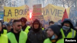 FILE - Protesters wearing yellow vests take part in a demonstration of the "yellow vests" movement in Marseille, France, Jan. 26, 2019.