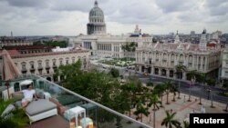 A tourist enjoys a rooftop of a recently renovated Belle Epoque shopping mall housing the Gran Hotel Manzana in Havana, Cuba, May 9, 2018. 