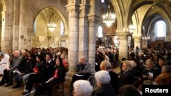 FILE - Local residents attend a mass at Saint-Baudile church in Neuilly-sur-Marne near Paris, France, Oct. 22, 2017. The Catholic church in France is now introducing digital collections during mass.
