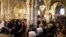 FILE - Local residents attend a mass at Saint-Baudile church in Neuilly-sur-Marne near Paris, France, Oct. 22, 2017. The Catholic church in France is now introducing digital collections during mass.