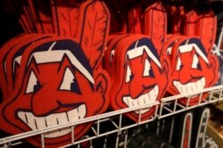 FILE - In this Jan. 29, 2018 file photo, foam images of the MLB baseball Cleveland Indians' mascot Chief Wahoo are displayed for sale at the Indians' team shop in Cleveland.