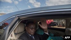 Cameroonian opposition leader Maurice Kamto sits in the back of a car as he is driven away on Oct. 5, 2019, the day of his release from prison in Yaounde.