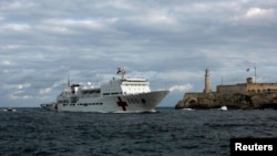 FILE - Chinese navy hospital-ship "Peace Ark" passes by the lighthouse of the colonial fortress Morro Cabana as it enters Havana Harbor.