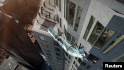 An artist rendering of the "Skyslide" attraction, an outdoor glass slide positioned close to 1,000 feet above downtown Los Angeles, California, is shown in this image released by OUE Skyspace, March 2, 2016