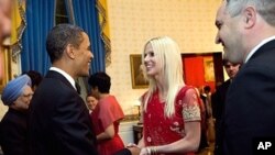 In this handout image provided by The White House, President Barack Obama greets Michaele Salahi and Tareq Salahi at a State Dinner in the State Dining Room of the White House November 24, 2009