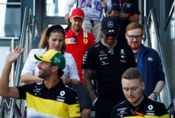 Mercedes' Lewis Hamilton, Renault's Daniel Ricciardo and Ferrari's Sebastian Vettel after the press conference, in Melbourne, Australia, March 12, 2020.