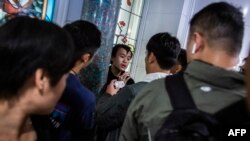 Plainclothes police officers detain a man (C) during a march through the Harbour City shopping mall in the Tsim Sha Tsui district of Hong Kong, Dec. 21, 2019.