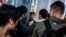 Plainclothes police officers detain a man (C) during a march through the Harbour City shopping mall in the Tsim Sha Tsui district of Hong Kong, Dec. 21, 2019.