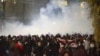 Demonstrators run away from a cloud of tear gas during a rally against the government's decision to suspend negotiations on joining the European Union for four years in Tbilisi, Georgia, Dec. 2, 2024.