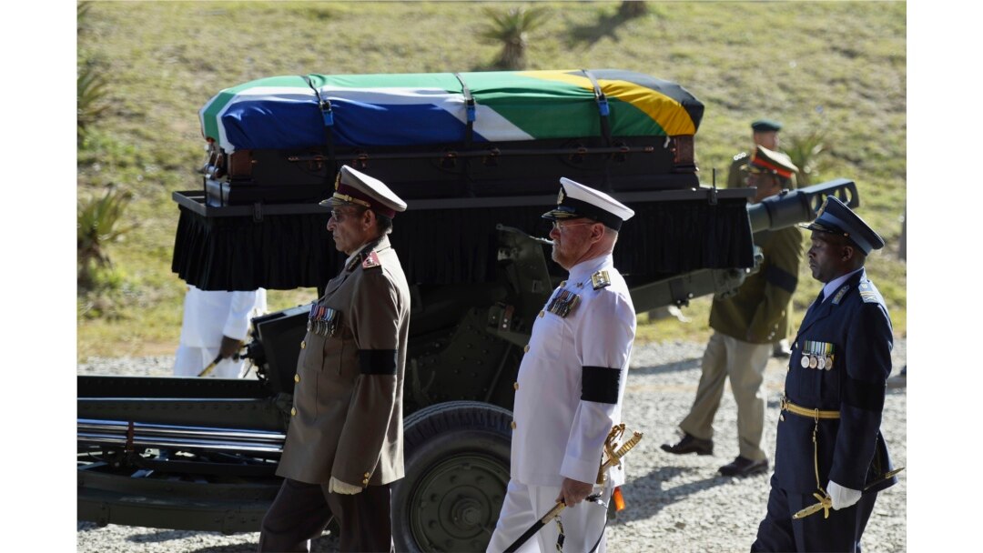 FILE - The coffin of South African former president Nelson Mandela is carried on a gun carriage for a traditional burial in Qunu, South Africa, Dec. 15, 2013.