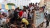 FILE: Cambodian migrant workers get off from a Thai truck upon their arrival from Thailand at a Cambodia-Thai international border gate in Poipet, Cambodia, Tuesday, June 17, 2014 (AP Photo/Heng Sinith)