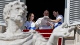 FILE - Pope Francis uses a tablet to register for Panama 2019 World Youth Day during the Angelus prayer in Saint Peter's Square at the Vatican, Feb. 11, 2018. 