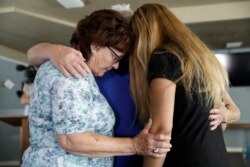 Alexandria Johnson, at right, whose home was damaged by an earthquake, prays with fellow congregants including Sara Smith, left, in the aftermath of an earthquake at the Christian Fellowship of Trona Sunday, July 7, 2019, in Trona, Calif.