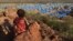 FILE - A boy sits atop a hill overlooking a refugee camp near the Chad-Sudan border, November 9, 2023. Hundreds of Masalit families from Sudan's West Darfur state were relocated months after fleeing an ethnically targeted massacre in the city of El Geneina. 
