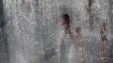 Children play in a water fountain in central London.