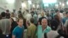 In this image made with a mobile phone camera, people leave a subway station in Moscow Wednesday, June 5, 2013. A rush-hour fire in Moscow’s subway injured dozens of people, forced the evacuation of thousands of commuters.