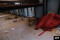 FILE - School bags and supplies belonging to pupils at the Government Science School are seen on the floor where gunmen abducted students, in Kankara, in northwestern Katsina state, Nigeria, Dec. 15, 2020.
