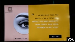 A screen at the Global Conference for Media Freedom shows tweets by female journalists about the dangers they face on the job.