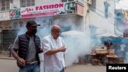 FILE - Madagascar's opposition member and presidential candidate Jean Jacques Ratsietison is escorted after police fired tear gas to disperse demonstrators attending his rally, in Antananarivo,Madagascar November 4, 2023. 