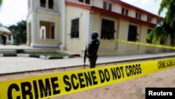 A police crime scene tape is seen in front of St. Francis Catholic Church where gunmen attacked worshippers during a Sunday mass service in Owo