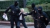 Opposition activist Nina Baginskaya, 73, struggles with police during a Belarusian opposition supporters rally at Independence Square in Minsk, Belarus, Aug. 26, 2020. Police have dispersed protesters, detaining dozens.