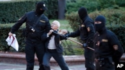 Opposition activist Nina Baginskaya, 73, struggles with police during a Belarusian opposition supporters rally at Independence Square in Minsk, Belarus, Aug. 26, 2020. Police have dispersed protesters, detaining dozens.
