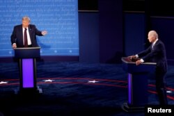 FILE - President Donald Trump and Democratic presidential nominee Joe Biden participate in their first 2020 presidential campaign debate in Cleveland, Ohio, Sept. 29, 2020.