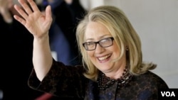 Hillary Rodham Clinton waves as she leaves the State Department, Feb. 1, 2013