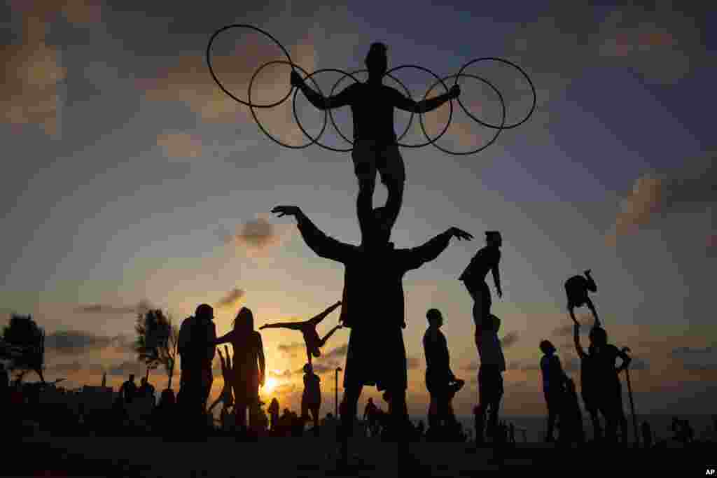 Acrobats perform gymnastic stunts during a nationwide lockdown to curb the spread of the COVID-19 virus at a park in Tel Aviv, Israel, Feb. 6, 2021.