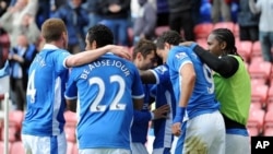 Des joueurs de l'équipe de Wigan lors d'un match, Wigan le 28 avril 2012