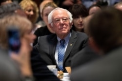 Democratic presidential candidate Sen. Bernie Sanders, I-Vt., listens as he is introduced during the Politics & Eggs breakfast at Saint Anselm College in Manchester, N.H., Feb. 7, 2020.