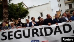 People hold a banner thats reads "Security" during a protest against drug trade and insecurity in the Campo de Gibraltar area, in Algeciras, southern Spain, May 17, 2018. 