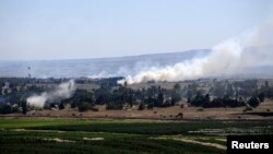 Smoke rises from the Israeli occupied Golan Heights near the Kuneitra border crossing, close to the ceasefire line between Israel and Syria, June 6, 2013.