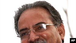 Maoist chairman Pushpa Kamal Dahal, aka Prachanda, looking down at cheering supporters as he rides around Kathmandu's Ring Road, 4 Apr 2010