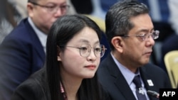 FILE - This handout photo taken on June 25, 2024, shows mayor Alice Leal Guo (L) of Bamban, Tarlac province, attending a hearing at the Senate in Manila. 