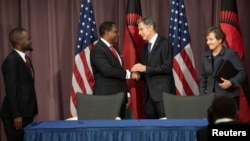FILE - Malawi's President Lazarus Chakwera shakes hands with U.S. Secretary of State Antony Blinken at a signing ceremony at the U.S. State Department, September 28, 2022